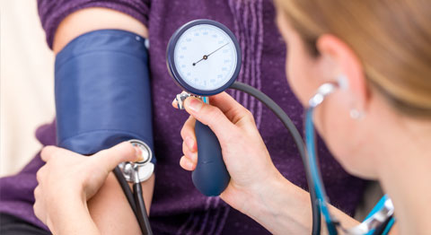 medical professional taking blood pressure reading