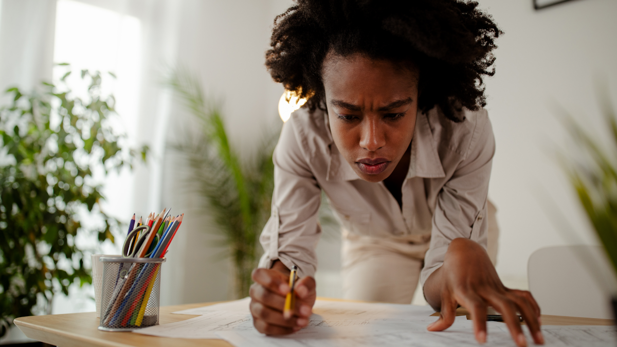 A person working at a desk with a pencil