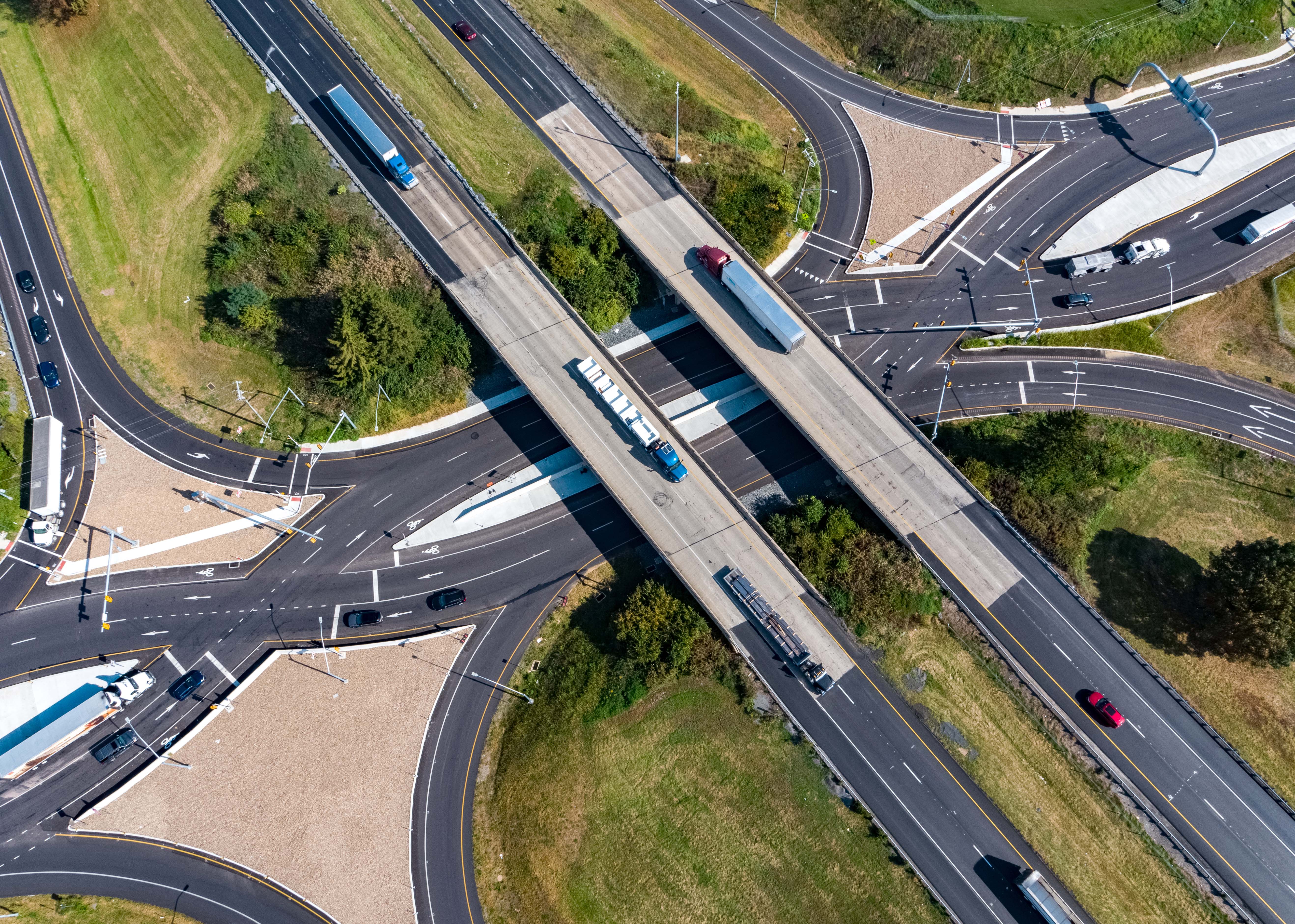 An aerial image of the newly constructed Diverging Diamond Interchange at 322/222, showing how crossroad traffic in both directions is transitioned or crossed over to the left side at a signal-controlled point and then transitioned back to the right side at a second signal-controlled point after passing through the interchange