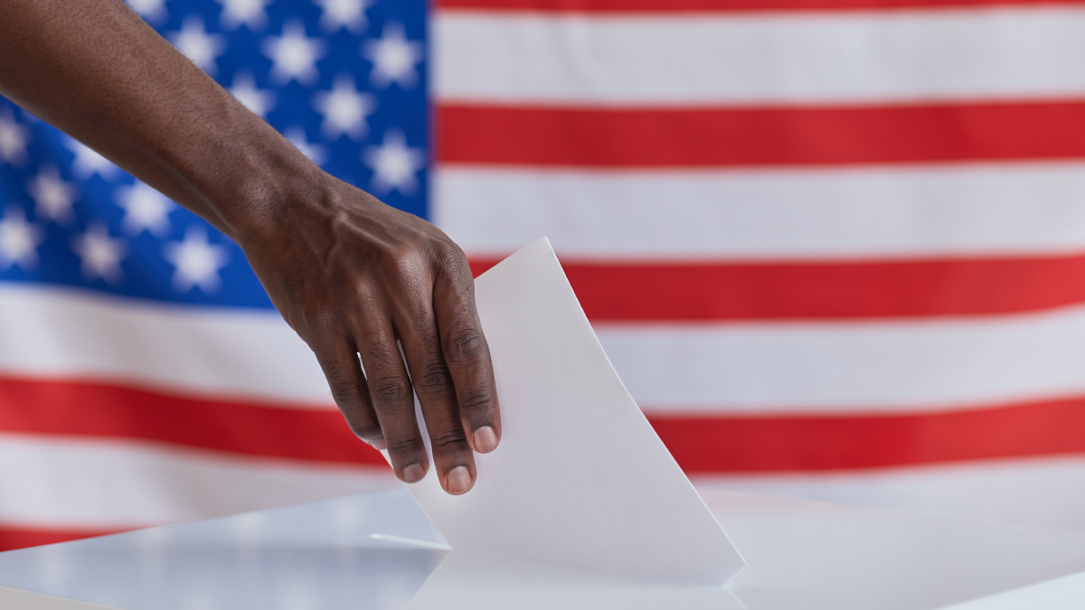 Person putting their ballot inside of a ballot box